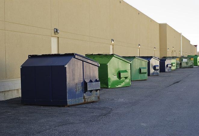 a forklift lifts a full dumpster from a work area in Bermuda Dunes, CA